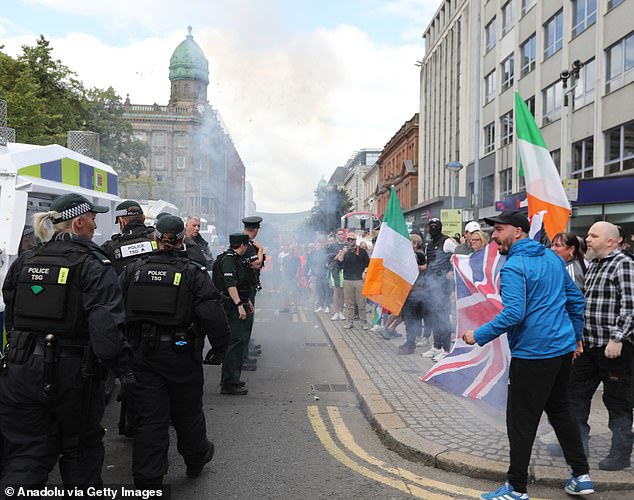 Protesters waving the union flag and the Irish tricolor took part in an anti-immigration protest outside Belfast City Hall, Northern Ireland, on August 3, 2024.