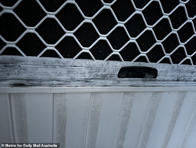 The railings and terrace door still had black fingerprint dust when Daily Mail Australia visited on Tuesday night.