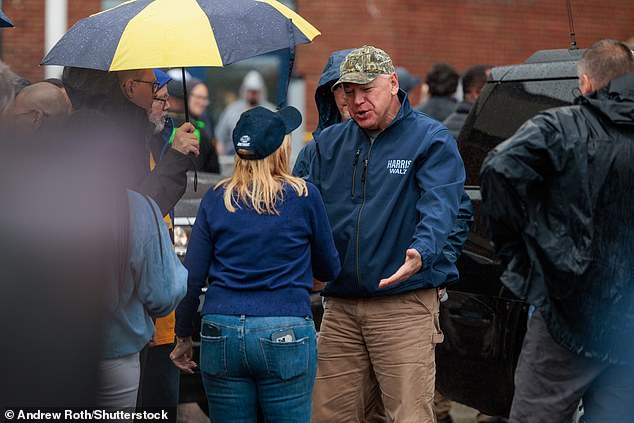 Minnesota Governor Tim Walz greets attendees at the tailgate of Michigan Stadium in Ann Arbor, Michigan.