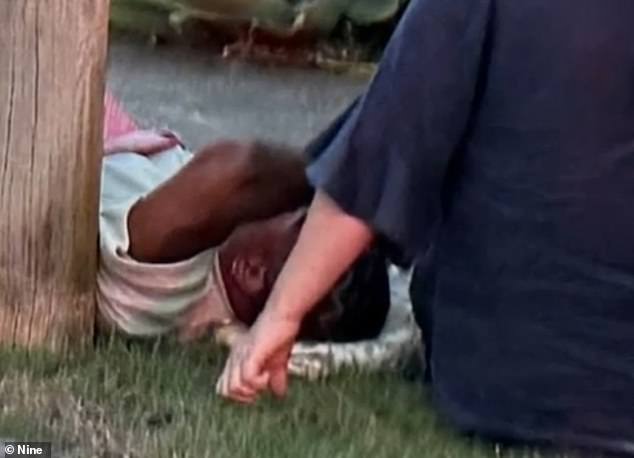 Mum was allegedly behind the wheel of a ute that crashed into an Uber in the Brisbane suburb of Bardon on Friday (Mum is pictured on the ground just after the collision).