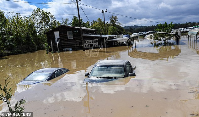 Cars remain submerged in a flooded area at a used tire dealership after Tropical Storm Helene in Hendersonville, North Carolina, USA, on September 27.