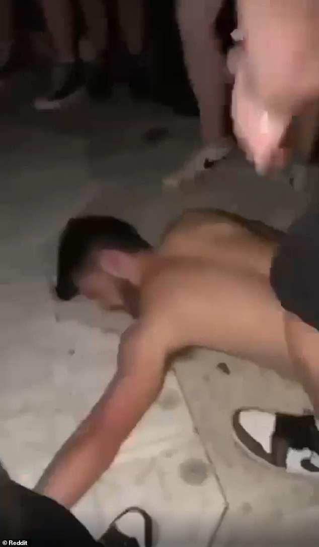 The video, allegedly taken at Travis' show on Thursday, shows a shirtless man apparently strangling another concertgoer before violently throwing him to the ground.