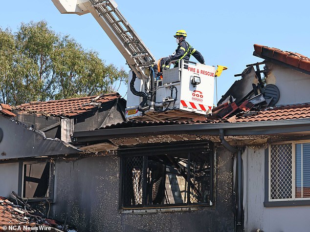 A family friend was living in the garage at the time of the fire, but had briefly left it to go shopping and returned home to find the house (pictured) in flames.