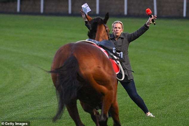 Trainer and TV host Amy Yargi tries to stop Via Sistina after James McDonald was knocked down Tuesday in Mooney Valley.