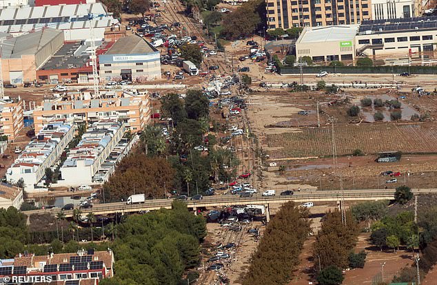 Aerial image showing mud-stained roads near Valencia covered with smashed cars and other debris.