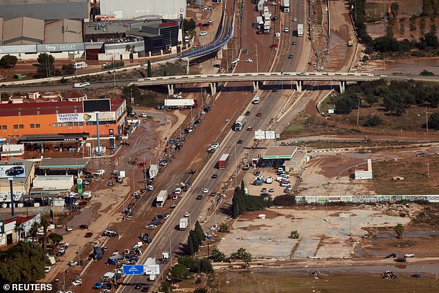 Abandoned cars on a mud-stained road near Valencia