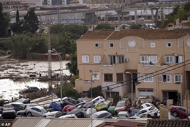 Vehicles are seen piled up after being swept away by floods in Valencia, Spain, Thursday, October 31, 2024.