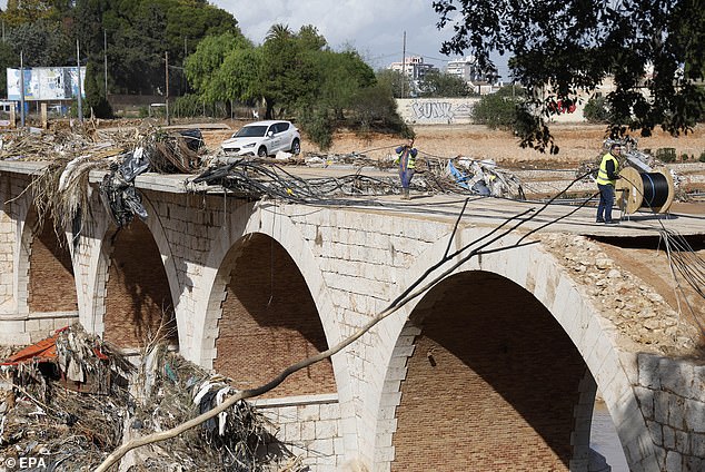 Workers try to restore power supply to residents of the flood-affected city of Torrent, Valencia province, Spain, October 31, 2024.