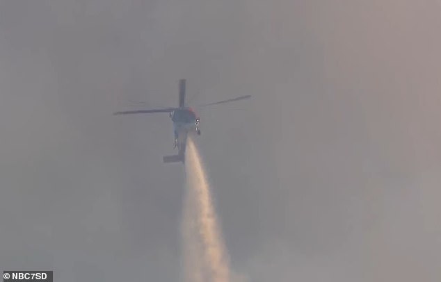 Crews from multiple agencies have been deployed to control the fire, including helicopter units that dropped water and fire retardant on the inferno from above.