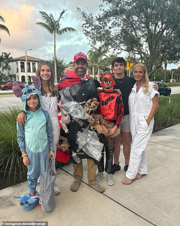 Donald Trump's eldest son poses with his family while they go trick-or-treating