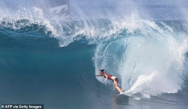 Larry didn't like Britain. He decided to use his funds to buy a ticket to Hawaii, where he joined the global community of surfers, made up of disaffected viscounts, drug addicts, misfits and runaways like him. Pictured: Australia's Tyler Wright takes part in Hawaii's Banzai pipeline