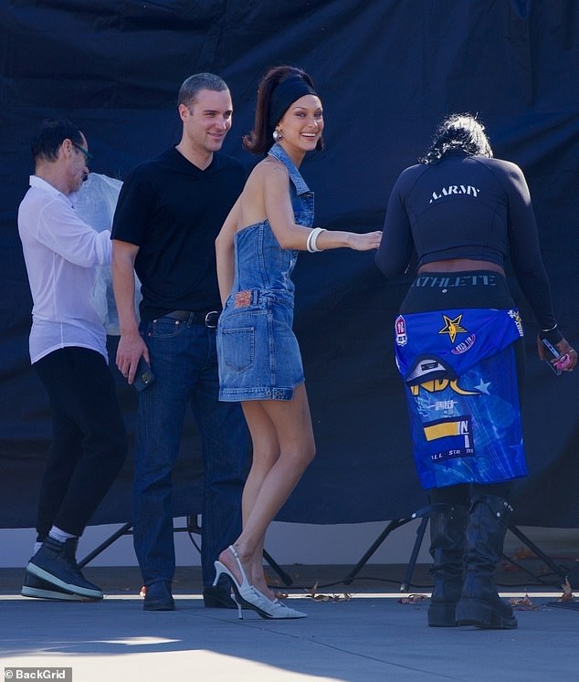 The catwalk star wore a denim minidress with a halter neck and a plunging neckline.