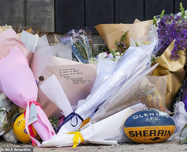 Flowers, messages and a football were left outside Auburn South Elementary School in Hawthorn East on Wednesday.