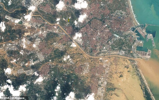 A satellite image of Valencia clearly shows where the worst affected areas of the city are, as brown floodwaters cover vast regions of land south of the city.