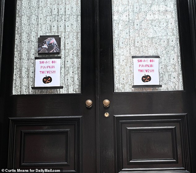 What appears to be surveillance footage of the robbery is also taped to the front door of his home.