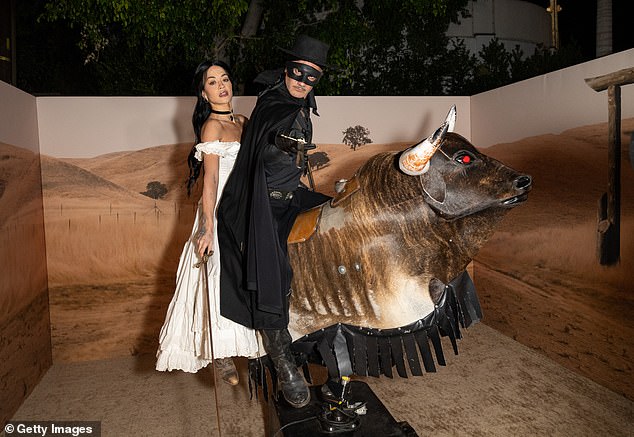 The couple certainly got into the spirit of things as they posed for a series of fun photos before riding a mechanical bull at the party.