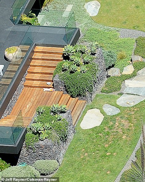 And while her dogs entertain themselves in their spacious kennel, the famous Zen star can relax in her own Asian-inspired patio complete with a pot of bubbling water, a spiritual temple structure, and black gravel with raked circular shapes.