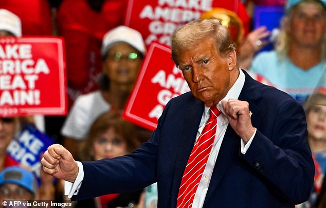 Republican presidential candidate Donald Trump dances as he leaves a campaign rally in North Carolina on October 30, 2024.