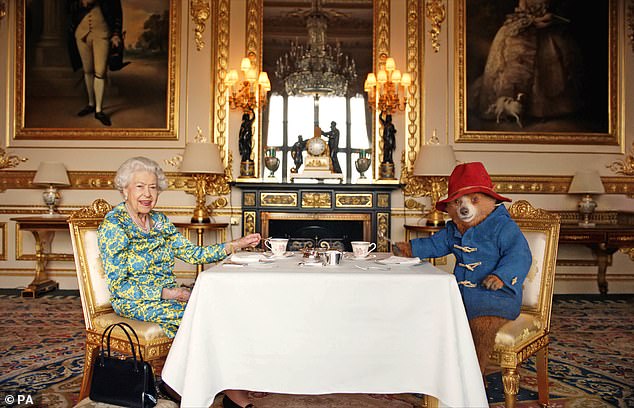 The late monarch's cameo will include a brief glimpse of her having afternoon tea with Paddington in Paddington, Peru (Queen Elizabeth II and Paddington pictured in June 2022).