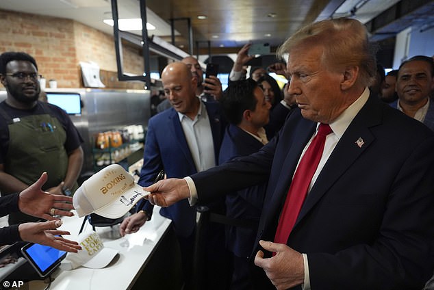 Trump signed a cap and posed for selfies during the visit