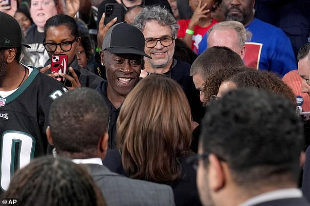 Democratic Vice Presidential candidate Kamala Harris, bottom center, greets 'Avengers' actors Don Cheadle, top center left, and Mark Ruffalo, top center right, after speaking during a community rally .