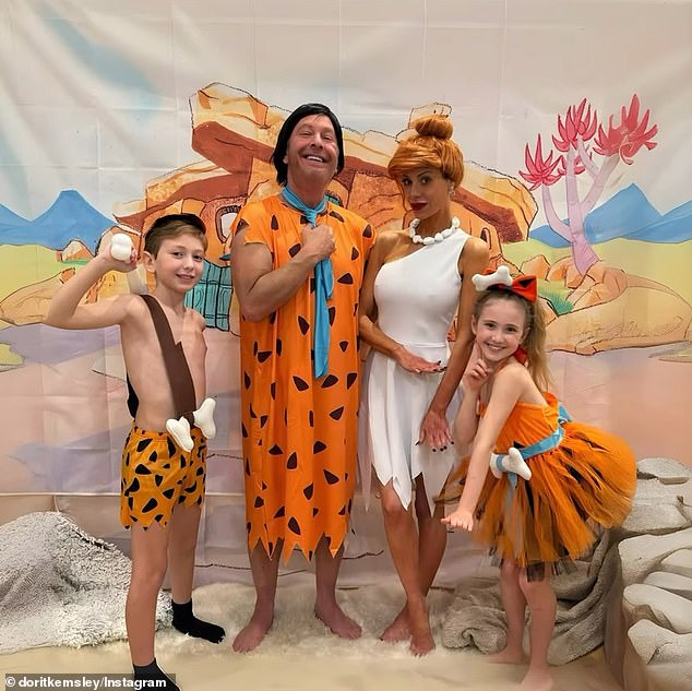 She shared photos of herself, her son Jagger, her daughter Phoenix and her ex-husband Paul dressed as The Flintstones for Halloween.