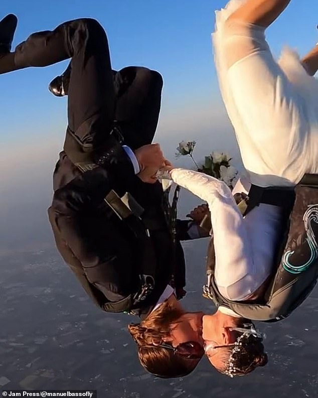 The couple was seen kissing in the air as they fell to earth from more than 10,000 feet.