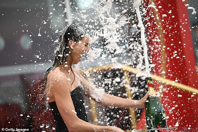 Throwing caution to the wind, Emma was literally drenched in champagne in scenes that delighted the assembled crowd.