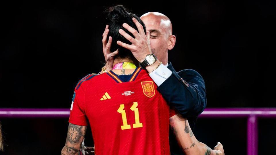 The president of the Royal Spanish Football Federation Luis Rubiales (right) kisses Jennifer Hermoso