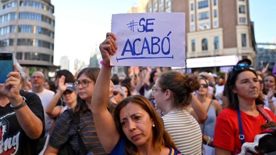 A protester holds a sign that says "it's over" ("it's over") during a demonstration called by feminist associations in support of the Spanish midfielder Jenni Hermoso, in Plaza Callao in Madrid on August 28, 2023. 