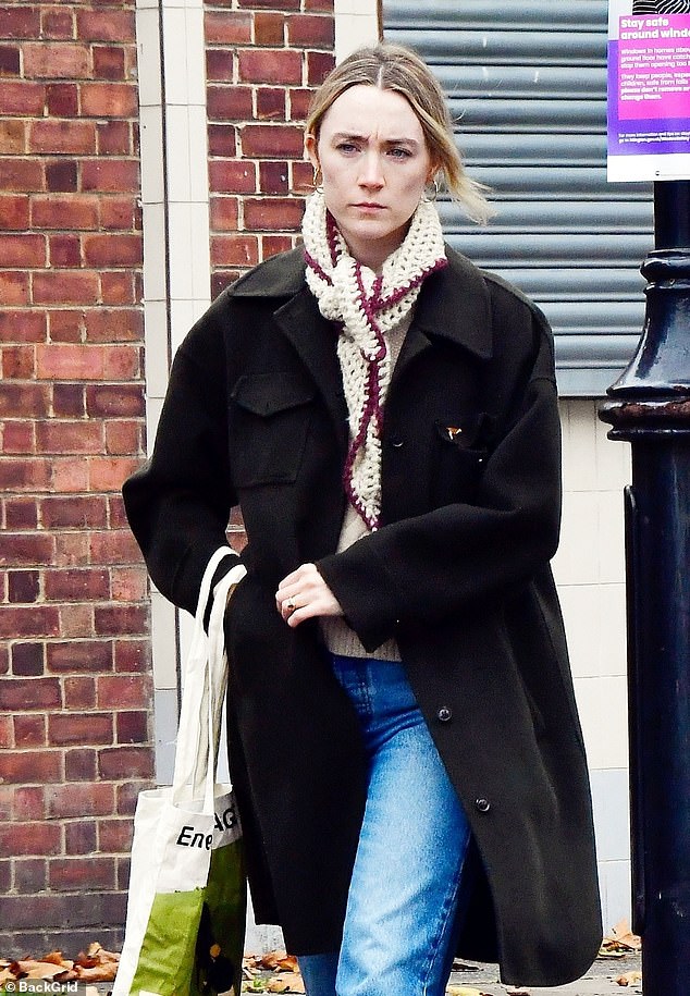 The actress, 30, donned a knee-length black coat for the outing, which she wore over a white sweater and blue jeans.