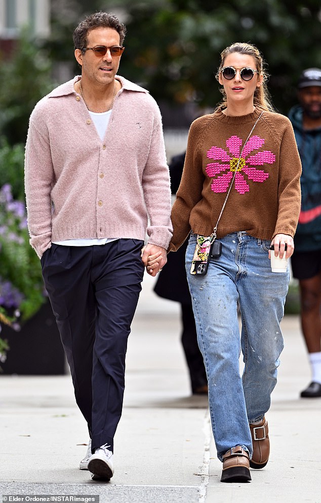 Actors Blake Lively and Ryan Reynolds hold hands while taking a morning walk in New York City last month.