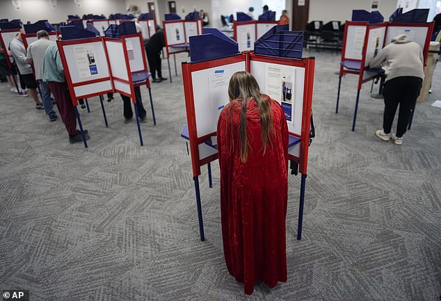 Voters fill out their ballots during in-person early voting at the Hamilton County Board of Elections, Thursday, Oct. 31, 2024, in Cincinnati.