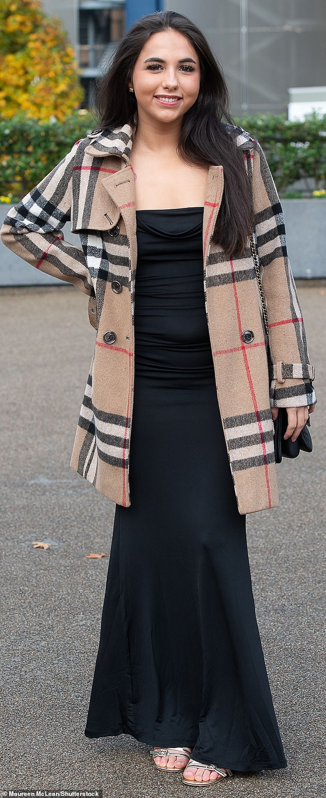 PREPARED: Opting for a dress in a lighter fabric and open-toed shoes, this guest made sure not to get too cold by finishing her look with a plaid coat.