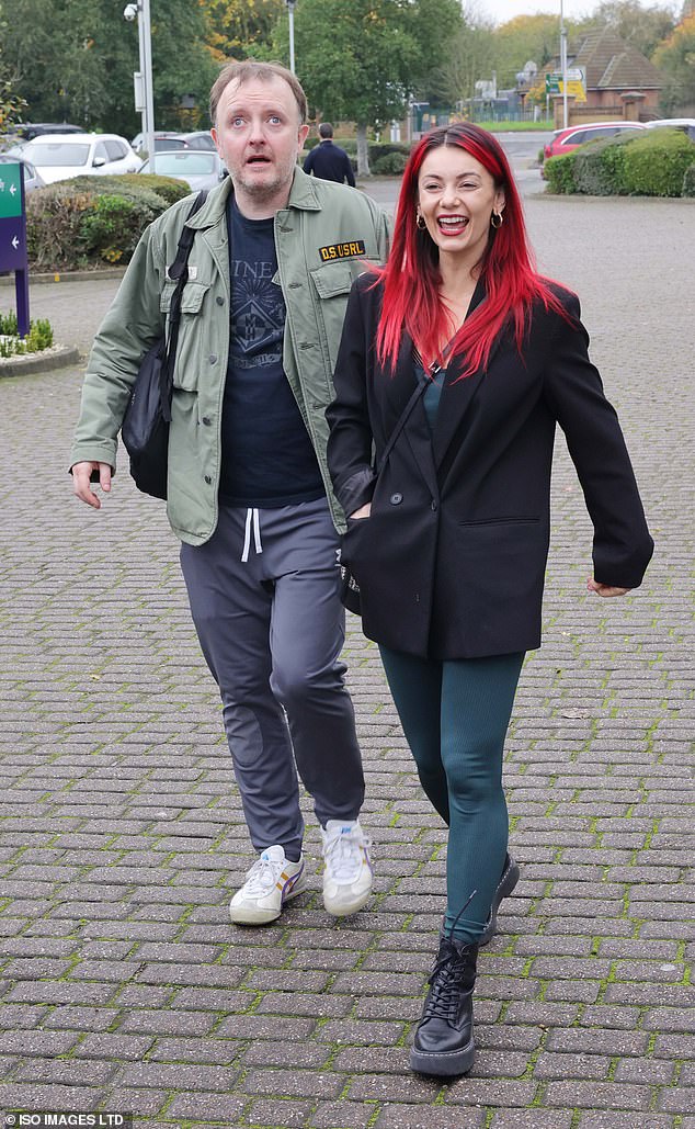 Dianne was all smiles as she walked in a green jumpsuit with a black buttoned coat and black Dr Marten boots while letting her bright red locks fall loose over her shoulders.