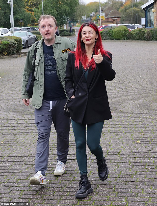 Dianne was all smiles as she walked in a green jumpsuit with a black button-up coat and black Dr. Marten boots, while Chris kept his style casual in a green jacket, blue T-shirt and gray jogging pants.