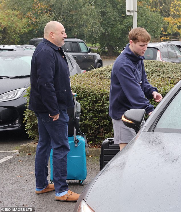 Wearing a pair of blue socks and brown Birkenstocks, the radio presenter carried his blue suitcase, while Jamie braved the cold in a pair of gray shorts.