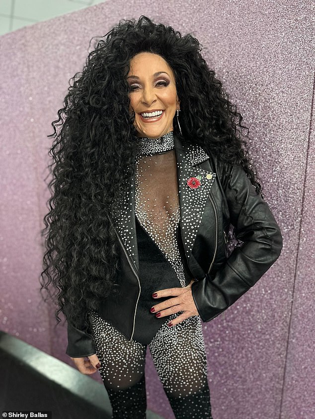 Shirley Ballas transformed into Cher while sporting a dramatic black wig and a daring, dazzling outfit.