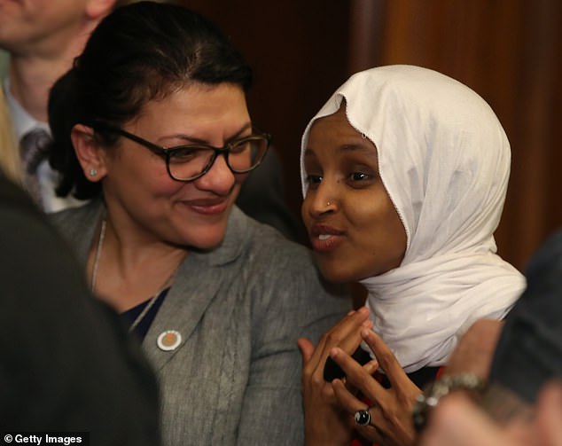 Omar speaks with his partner Rashida Tlaib during a press conference on March 13, 2019.