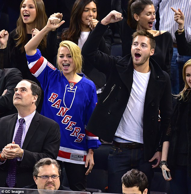 Tom and Margot met in 2013 while working on Suite Française, where he was an assistant director and she was in front of the camera. Pictured: at an ice hockey game in 2015.