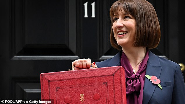 Britain's Chancellor of the Exchequer Rachel Reeves poses with the red budget box as she leaves 11 Downing Street in central London on October 30, 2024.