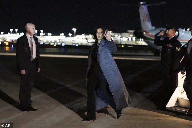 Kamala Harris is seen waving to photographers as she lands at LaGuardia Airport on Saturday night ahead of her surprise appearance on SNL.