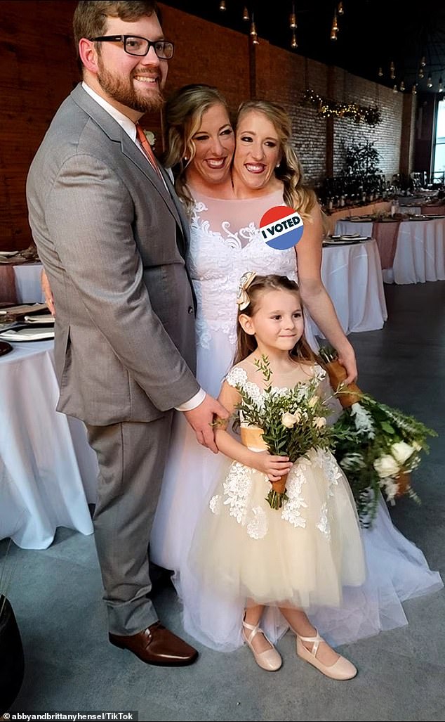 Another photo showed Isabella, dressed in a flower girl outfit and holding a bouquet, posing with them.