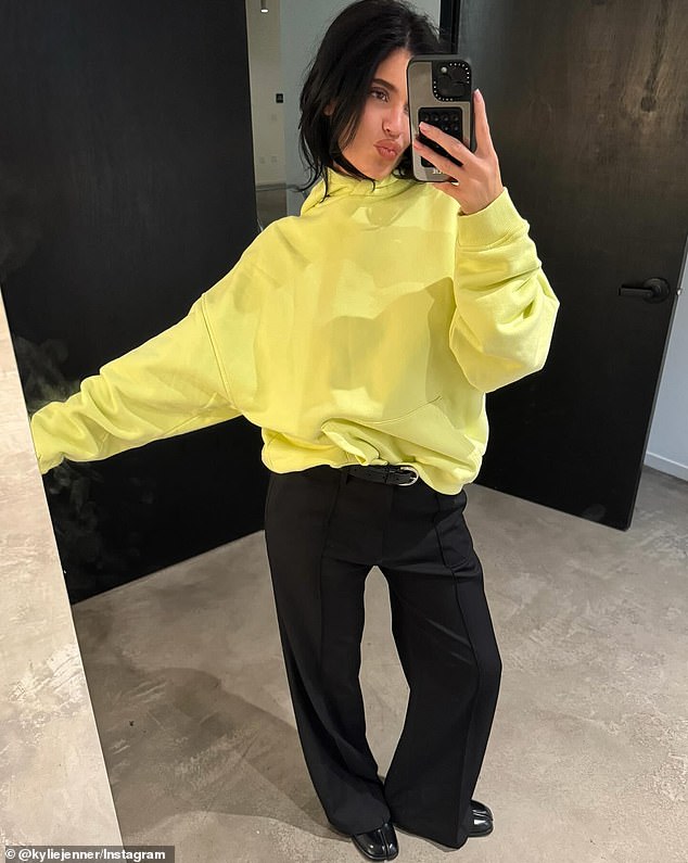 The youngest of the Kardashian-Jenner brood would also share a full-body photo of herself wearing black pants, a yellow hoodie, and black leather shoes, all while pursing her lips.