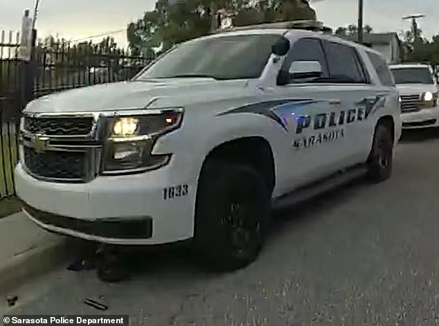 The eight-year-old boy's dirt bike ended up under the police car after being hit