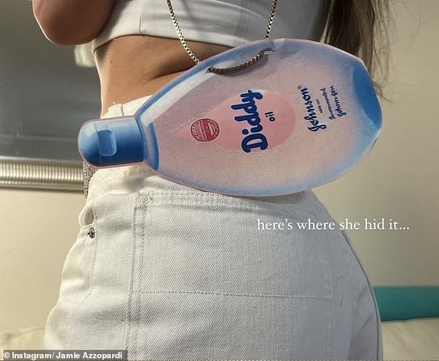 DJ Helena wore a white top, headband, and jean shorts for her Jennifer Lopez costume, paired with a handmade bag featuring the same image of a baby oil bottle.