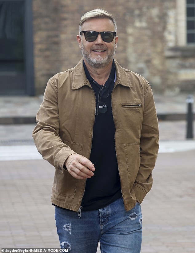 Gary, 53, looked effortlessly chic as he left the studios. in the photo