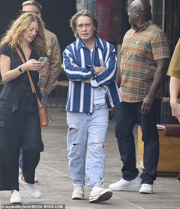 Meanwhile, Mark Owen, 52, showed off his quirky style in a blue and white striped overshirt over a casual T-shirt.