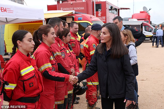 Queen Letizia greets Portuguese rescuers after their arrival at the flood control station in Paiporta