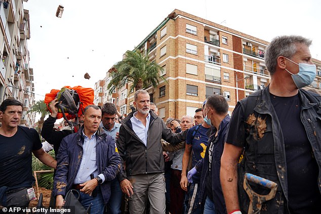 King Philip of Spain was booed and pelted with mud by angry locals during his visit to Valencia, where more than 200 people died in devastating floods.